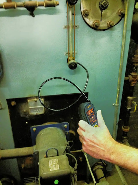 Hand using PalmScope Compact Borescope Video Inspection Camera Grey, Pocket-Sized Handheld for machine inspection