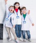 Children wearing Kid Friendly Lab Coat Science Kit Costume Set With Goggles And ID Cards 12 Sets, smiling in classroom.