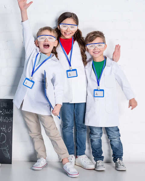 Three kids wearing six set of white kids lab coats with goggles and ID card holders, 18 piece doctor scientist dress up kit for boys and girls
