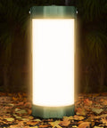 106 LED Camping Lantern With 5000mAh Battery, Up To 80 Hours Of Light, 1200 Lumens glowing on forest floor