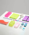 Desktop office supplies including colorful folders, bins, and stationery on a white desk, suitable for organizing home or office.