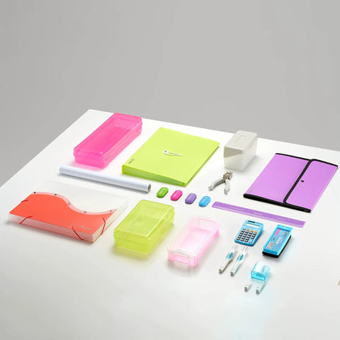 Desktop office supplies including colorful folders, bins, and stationery on a white desk, suitable for organizing home or office.