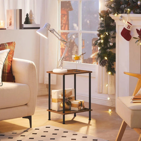 Industrial Style End Table for Small Spaces, Rustic Brown Two-Tier Side Table with Stable Frame, Nightstand or Sofa Table, Easy Assembly, Space-Saving Storage for Living Room or Bedroom shown beside a sofa with gifts and holiday decor