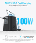 Black nine-in-one desktop power strip with USB-C ports charging a laptop, labeled 100W, highlighting fast charging capabilities.
