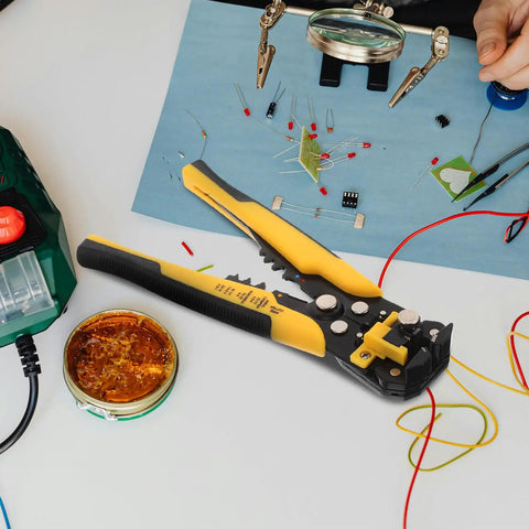 Kickass Heavy Duty Auto Wire Stripper And Crimping Pliers Pro Gear For Electricians on a workspace with tools and wires.