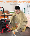Person using 100Ft Electric Drain Cleaner Machine With Auto Feed Direction Control Sewer Snake for clogged drain.