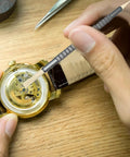 Precision Watch Cleaning Pen With Double Head Rubber Tips For Dials, Case Gaps, And Gear Clearance in use on watch gears