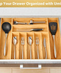 Straight Up Expandable Bamboo Kitchen Drawer Organizer With 2.5 Inch Elevated Sides And Curved Grooves showing sorted utensils in a drawer.