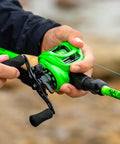 Legit Zephyr Dual Tip Casting Fishing Combo Featuring Ultra Light Im6 Graphite Rod And Left Hand Reel in green color during use.