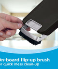 Close-up of Powerful Cordless Handheld Vacuum For Cars And Home With Pivoting Nozzle showing flip-up brush attachment.