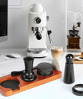 All In One 7 Piece Espresso Accessories Kit For Home Baristas Includes 54mm Espresso Tamper WDT Needle Stirrer Wood Tamping Station Dosing Funnel Brush Puck Screen And Distributor For Perfect Clean Shots Every Time displayed on countertop