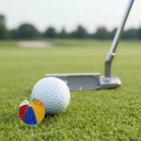 Beach Ball Crystal Golf Marker For Putting Green, Premium 1 Inch Ball Marker by a white golf ball and putter on green