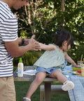 All Mineral Baby Sunscreen Spray SPF 50 With Broad Spectrum UVA UVB Protection on table during family picnic
