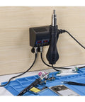 Pro Grade 2 in 1 Soldering Station With Hot Air Rework 800W, Dual LCD Displays on a workbench with tools and phone repair items