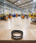 Premium Drop In Replacement Drive Belt For Pho 15 82 16 82 20 82 Planers on a wooden table in a factory setting.