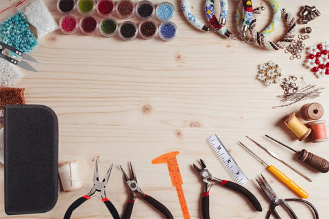 19 Piece Jewelry Making Tools Kit With Zipper Storage Case For Crafting And Repair Perfect DIY Beading And Wirework Set For Beginners And Pros At Home displayed on a wooden table with pliers, needles, and beads.
