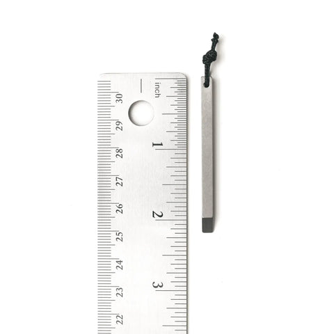 Ultra Lightweight Titanium Keychain Pry Bar With Minimalist Slim Design Everyday Carry Essential next to a ruler for size reference.