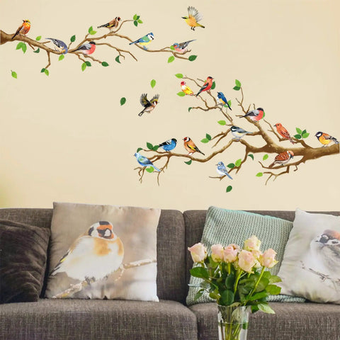 Hummingbird On Tree Branch Wall Sticker Set With Green Leaf And Flying Bird DIY Vinyl Wall Decal above a gray couch with bird pillows.