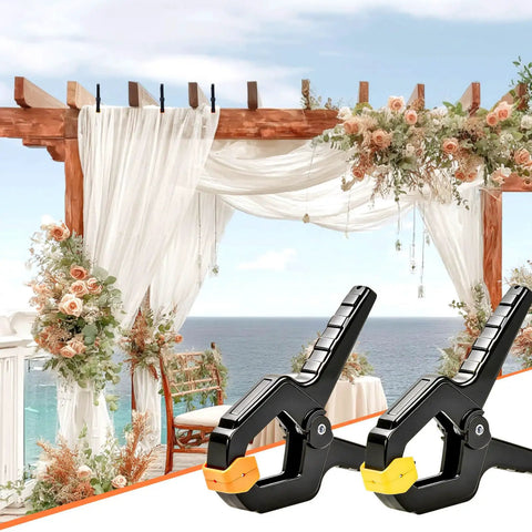 Hella Durable Plastic Spring Clamps 18 Pack 3.5 Inch Black Grip Clips holding fabric on a floral wedding arch backdrop.