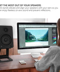 Rock Solid Elevated Desktop Speaker Stands For Large Bookshelf Speakers And Full Size Studio Monitors Six Point Nine Inch Tall Twenty Two Lbs Reduces Resonance With Two Point Five Millimeter Damping Padding One Quarter Twenty Mounting Pair Black supporting large speaker next to computer monitor on desk.