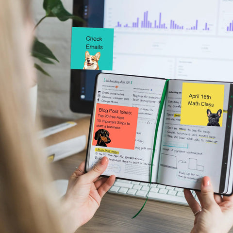 Person using 9 Pads Totally Cute Sticky Notes Set 3x3 Inch Dog Self Stick Notepads for reminders on a notebook and monitor.