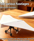 Turn Paper Planes Into A Dope Remote Control Flyer With Gyro Stabilizer, DIY glider with dual propellers on wooden table.