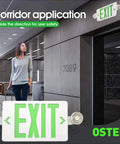 Green LED Exit Sign With Battery Backup And Emergency Lights, 4 Pack, shown in a hallway application, indicating exit direction