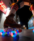 Close-up of skater using Cosmo Glow LED Outdoor Roller Skate Wheels Quad Pack 62mm By 32mm White Rain Glow with bright light at night