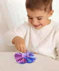 Child playing with 3D Printed Gear Sphere Fidget Toy For Sensory Stress Relief And Chill, a deep purple 2.6-inch desk accessory.