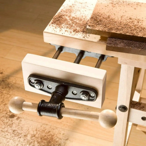 Heavy Duty Carpentry Bench Vise With Manual Threaded Screw For Tightening Workpieces During DIY Cutting Or Sanding And Assembly Projects In Your Workshop on a wood tabletop.