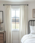 Heavy Duty 1 Inch Industrial Wrap Around Curtain Rod In Black installed above window with white curtains in bedroom.