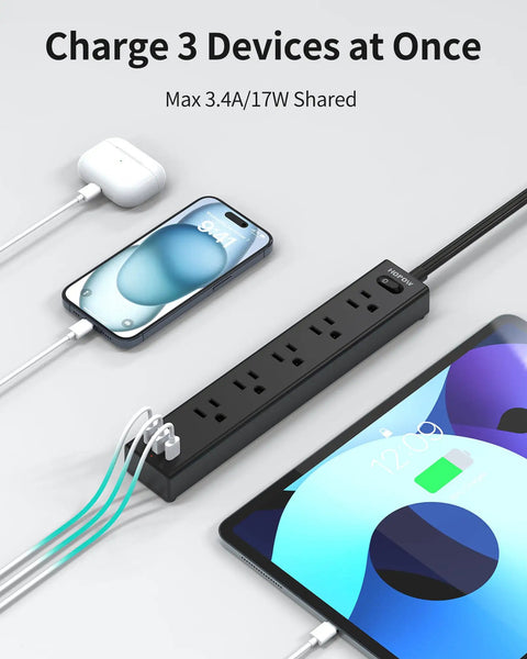 Ultra Thin Flat Plug Power Strip With 6 Foot Cord, 5 Outlets And 3 USB Ports Including 2 USB C, in use charging devices.