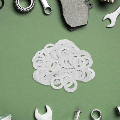 Stainless Steel Spindle Washers for Door Knob Kits, 100 Pack Flat Thin Silver Metal Washers, Noise Reduction for Quiet, Smooth Operation, Easy Install, Durable Hardware Upgrade for Home Renovation and Residential Use. Flat silver washers piled on green surface