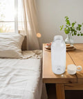 Leakproof Sports Water Bottle With Handle For On The Go Hydration, BPA Free 650ml Travel Flask on wooden table near bed
