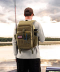 Person wearing Fishing Tackle Backpack With Rod And Gear Holder For All Day Outdoor Use Lightweight Water Resistant Shoulder Bag