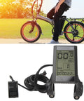 22.2mm LCD Cycling Computer For E Bikes Multifunctional Display Meter showcasing speedometer and battery voltage monitor. Bicycle in background