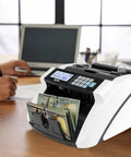 High Speed Money Counter With Multi Currency Detection, Counterfeit Bill Detector on an office desk with LCD display and banknotes