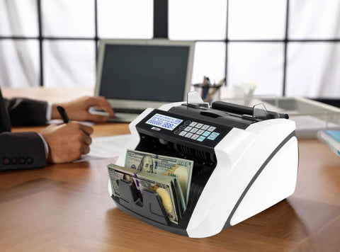 High Speed Money Counter With Multi Currency Detection, Counterfeit Bill Detector on an office desk with LCD display and banknotes