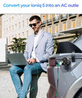 Road Tripping Got You Covered V2L Adapter Compatible With Hyundai Ioniq 5 And Ioniq 6 Plus Kia EV6 connected for laptop use.
