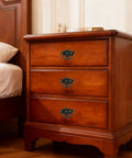 Wooden bedside cabinet with vintage antique cabinet bail pull handles set of 8 in bronze finish, drop ring pulls installed on drawers.