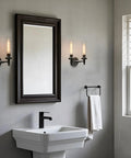 Rustic Industrial Wall Sconce Light With Tubular Clear Glass Lampshades, Matte Black Finish, Double Sconce Set beside mirror