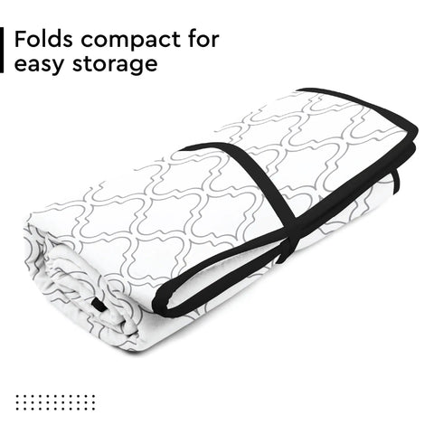 Big 48x28 Inch Ironing Mat Pad With 3mm Padding And Silicone Iron Rest folded with white tiles pattern for storage.