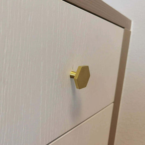 Top Tier Solid Brushed Brass Hexagon Knobs 6 Pack For Kitchen Cabinets And Drawers With Mounting Hardware 1.2 Inch Design on white drawer.