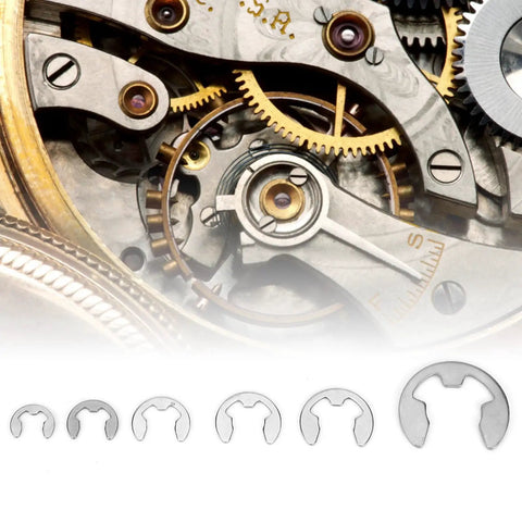 Stainless Steel E Clip Set 300 Pcs Assortment Kit M One Point Two Through M Fifteen With Storage Box For Auto Hobbyists And DIY Projects E Type Retaining Circlips displayed beneath intricate watch mechanism.