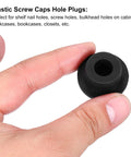 Close-up of a Three Pack T Shaped Silicone Plugs 20mm Diameter Snap In Hole Seal Covers Black Round Rubber Stopper held between fingers