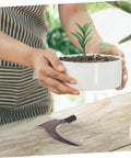Long Handled Manganese Steel Multi Functional Sickle For Weeding And Harvesting With Ergonomic No Sweat Grip on wooden table
