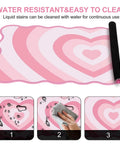 Pink Heart XXL Mouse Pad With Scalloped Edge Large Desk Mat For Gaming And Work Non Slip Rubber Base Waterproof Desktop Pad For Laptop And Computer 35.4 By 15.7 Inches Cute Pink Office Accessory shown with water resistance feature.
