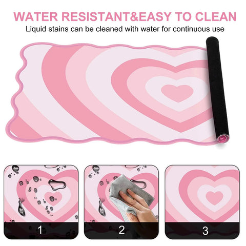 Pink Heart XXL Mouse Pad With Scalloped Edge Large Desk Mat For Gaming And Work Non Slip Rubber Base Waterproof Desktop Pad For Laptop And Computer 35.4 By 15.7 Inches Cute Pink Office Accessory shown with water resistance feature.