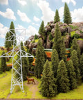 Totally Legit N Scale 1 160 Miniature Electric Transmission Tower in a model railroad diorama with trees and rocks.