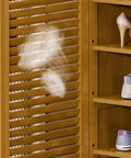 Spacious Six Tier Freestanding Shoe Cabinet Boasting Four Doors And A Nifty Drawer To Stow Away Your Best Kickers In Style with shoes visible.